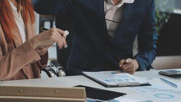 Group of casually dressed asian businesspeople discussing ideas in the office. Creative professionals gathered at the meeting table for discuss important issues of the new successful startup project video