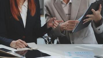 Group of casually dressed asian businesspeople discussing ideas in the office. Creative professionals gathered at the meeting table for discuss important issues of the new successful startup project video