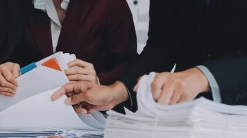 Group of casually dressed asian businesspeople discussing ideas in the office. Creative professionals gathered at the meeting table for discuss important issues of the new successful startup project video