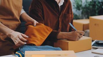 couple start up small business owner are thrilled with their success in online sales and e-commerce. video