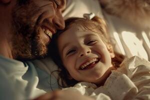 A man and a little girl are cuddling and smiling photo