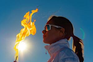A woman holding a torch in the sky photo