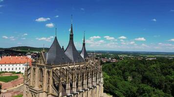 Aerial close orbiting view of St Barbara cathedral in Kutna Hora in Czechia in June 2024 video