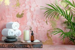A wooden tray with a few white towels and a bottle of lotion sits on a pink wall photo