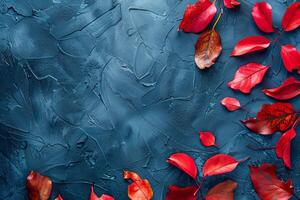 Autumn background with colored red leaves on blue slate background. Top view, copy space photo