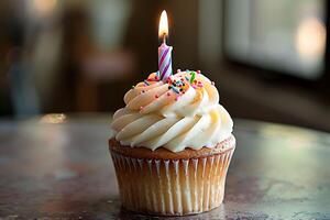 Single frosted cupcake with lit birthday candle and sprinkles. Perfect image for celebrations, birthdays, or special occasions. photo