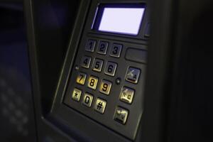 Close-up view of an ATM keypad with illuminated buttons in a low-light setting photo