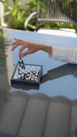 Enjoy an intense indoor chess game between two players playing on a reflective table video
