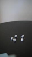 A group of friends enjoying a dice game on a black table, having fun while being competitive video