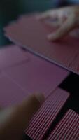 A closeup image capturing the intricate details of hands holding playing cards video