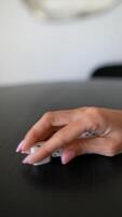 Person rolling dice on black table in closeup, capturing motion and excitement of gaming video