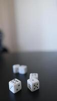 Engaging in a minimalist setting, participating in a game of dice and hand gestures video