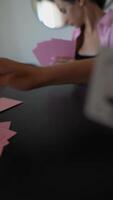 A group of women playing a card game with great focus and concentration at a table video
