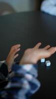 Capturing candid images of dice and hands in a playful setting, playing a fun game with loved ones video