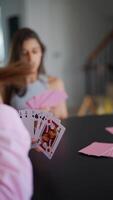 A group of people enjoying a card game indoors, socializing and having a good time together video
