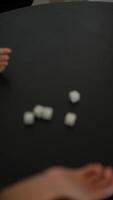 Hands are actively rolling dice on a black table, creating an entertaining gaming scene video