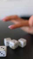 A captivating image featuring a hand in interaction with a cluster of dice on a tabletop video