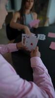 An entertaining card game is in progress among friends in a comfortable home environment video