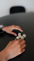 The dice are being rolled on the black table in a gaming setup with players around video