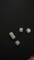 Rolling dice on a table, hands in motion, creating an atmosphere of excitement and anticipation video