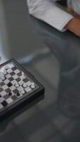 Experience a Mini Chess Game Live, Featuring Players Using Their Hands to Move Pieces video