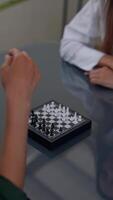 Participants engaged in a smallscale chess match, focused on utilizing strategy and skill video