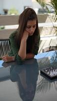 A woman plays chess with focus and composure in a serene setting, creating a thoughtful atmosphere video