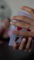 Magician showcasing complex card tricks with skill, emphasizing finger movements and deck details video