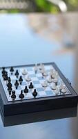 Two hands are actively engaged in a smallscale chess match on a tiny chessboard video
