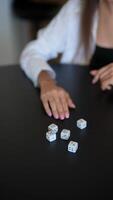 A group of friends gathered around a table, deeply engaged in a lively dice game video