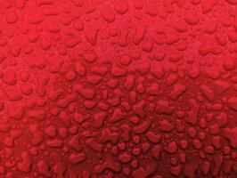 Water drops on metallic red shiny metal background, wet after rain, template, wallpaper photo