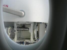 Through aircraft window on passenger seat, details of door visible. Perfect for travel and aviation content. Window view showing aircraft interior and door perspective through window during flight. photo