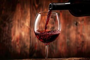 Pouring red wine into a glass with a wooden background photo