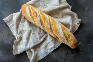 Freshly baked baguette on a light cloth photo