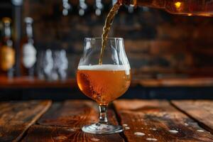 Pouring beer into a glass on a rustic wooden table photo