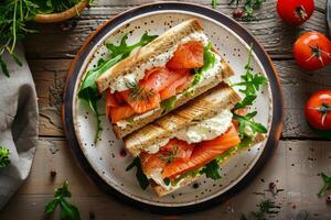 Salmon and cream cheese sandwich with fresh greens on a rustic plate photo