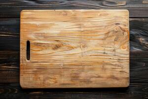 Empty wooden cutting board on dark wooden background photo
