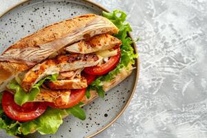 Chicken sandwich with lettuce, tomatoes, cheese on whole grain bread photo