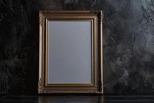 Elegant empty gold frame against a dark, textured wall photo