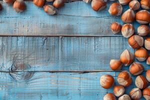 Hazelnuts scattered on a rustic blue wooden background, highlighting their natural texture and color photo