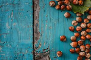 Hazelnuts scattered on a rustic blue wooden background photo