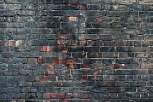Charred brick wall with dark, burnt textures, showing significant fire damage and wear photo
