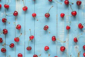 Cherries on a blue rustic wooden background photo