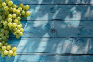 Green grapes on a blue rustic wooden background photo