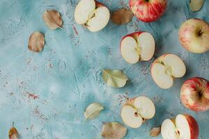 Whole and halved apples on a table, top view photo