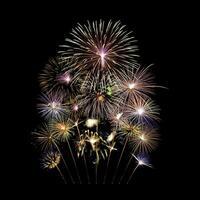 Fireworks of various colors and shapes burst in night sky photo