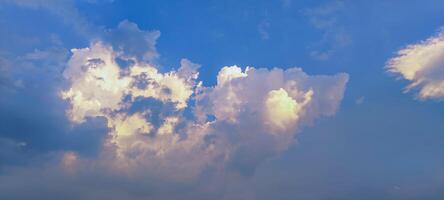 a cloud that is white and fluffy, a large cloud formation is seen in the blue sky, photo