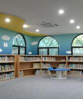 A neatly organized bookshelf nestled within the serene confines of the library photo
