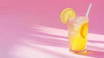 A summer cocktail on a blank pink background with tropical leaves photo