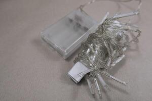 Selective focus flat lay string Christmas lights storage. Neatly wrapped up garland on background photo